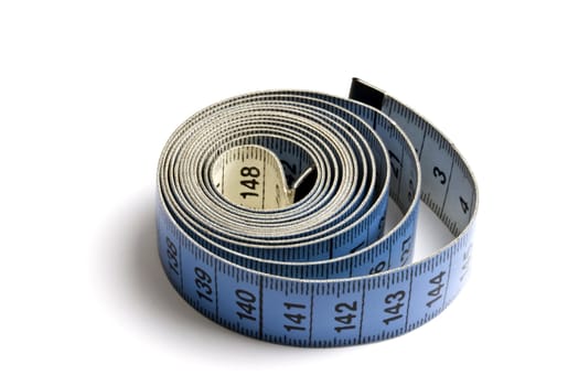 Blue tape measure  rolled on white background 
