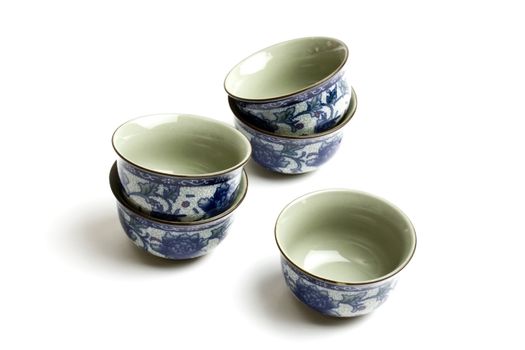 Few small cups of tea isolated on white