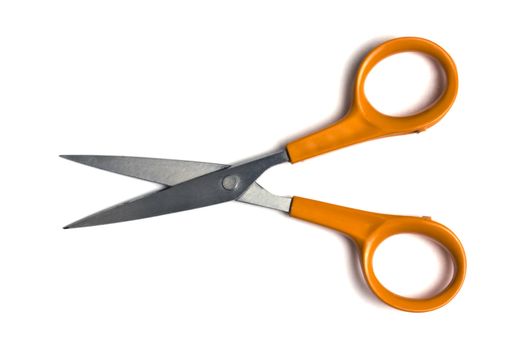 Orange scissors isolated on white background 