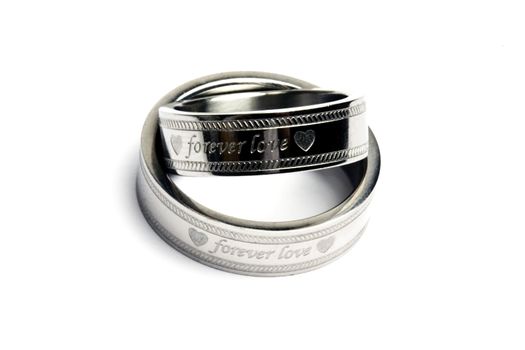 Wedding rings of Forever Love isolated on white 

