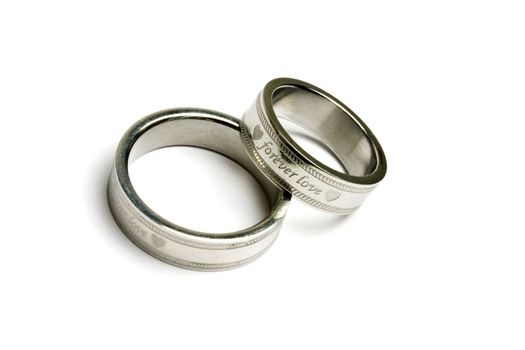 Wedding rings of Forever Love isolated on white 