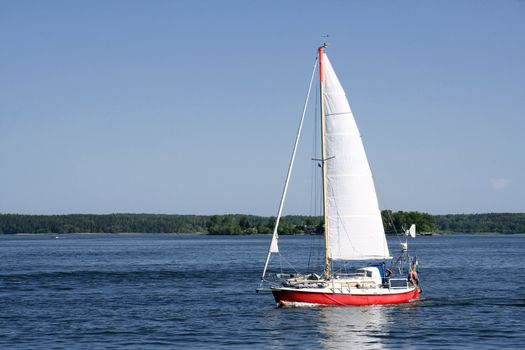 A Samll sailing boat in blueand calm sea