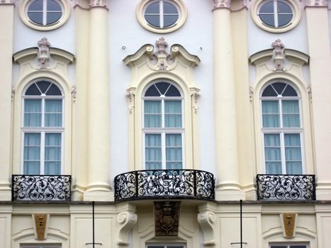 Classic windows with statues and balconies in Prague 

