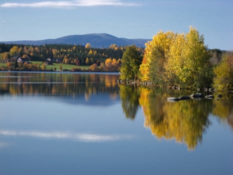 Autumn landscape of mirror lake and colorful trees 
