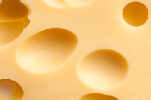 Maasdam cheese texture with holes close up
