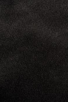 Black satin fabric background closeup. 
