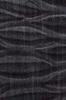 Texture of black jeans background closeup