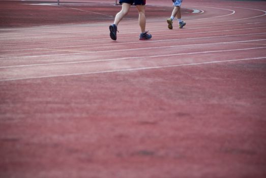 Leg of runner on racetrack, Bangkok, Thailand.