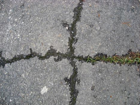 Cracks on asphalt background 