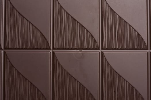 Delicious dark chocolate background closeup
