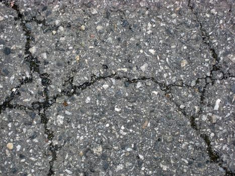 Cracks on asphalt background 
