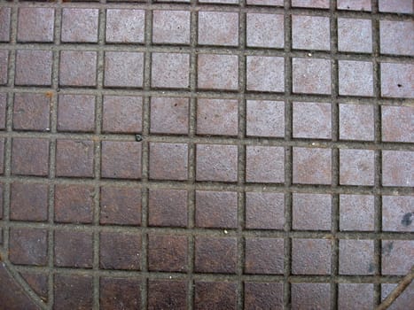 Texture of red small square brick structure ground
