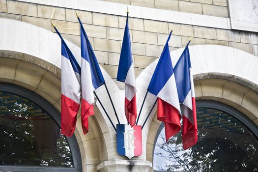 Few mini French flags on the wall in Paris