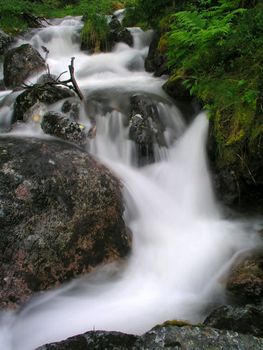 Beautiful landscape of flowing water from mountain stream 
