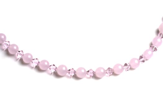 Beautiful pink string of beads closeup on white background 