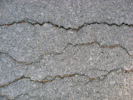 Texture of cracks on asphalt background 