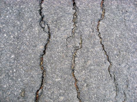 Texture of cracks on asphalt background 
