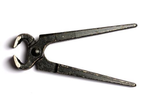 Old black tongs isolated on white background