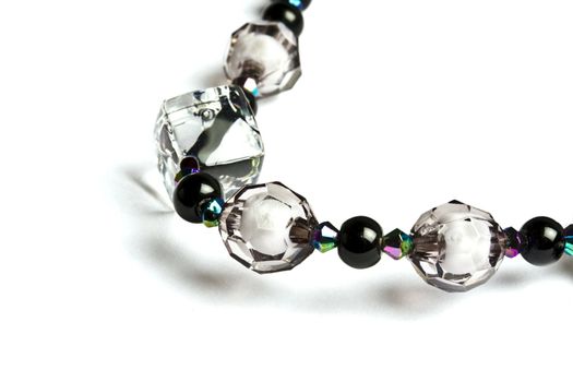 string of beads closeup on white background 