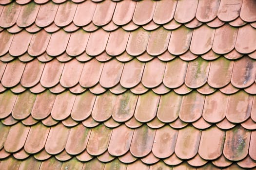 Texture of old red tiled roof background . Prague old building