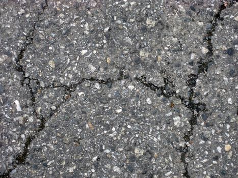 Cracks on asphalt background 
