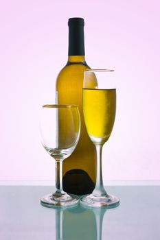 Bottles and glasses of wine on magenta background