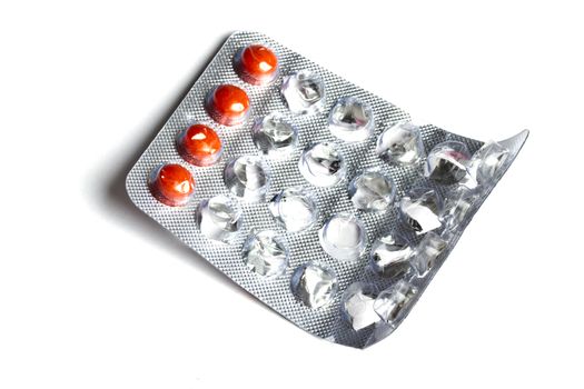 some red pills isolated on white background 
