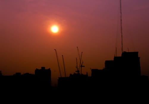 City under construction at sunrise silhouette