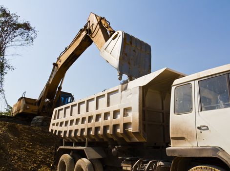 Excavator loader and truck during earthmoving works outdoors  at the quarry