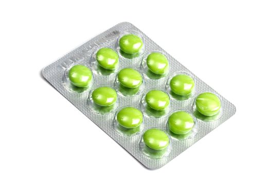 Package of green pills isolated on white background 