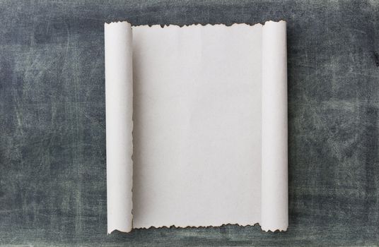 Old paper scroll on a blackbroad background