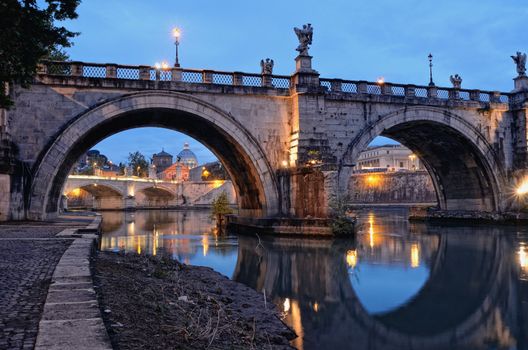 Bridge crossing the river Tiber in twilight