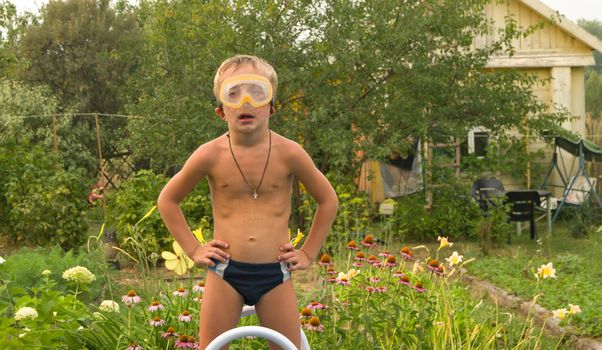 Boy in scuba mask at the garden site.