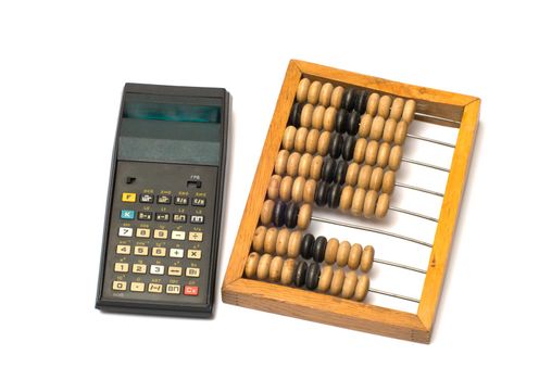Old calculator and wooden abacus on white background.