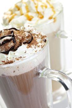 Hot chocolate and coffee latte beverages with whipped cream