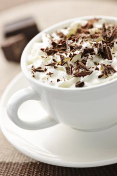 Cup of hot cocoa with shaved chocolate and whipped cream