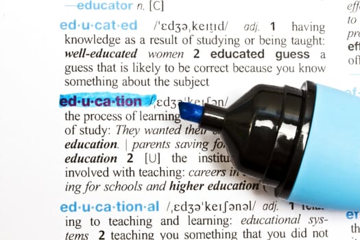 The word " EDUCATION" highlighted in a dictionary