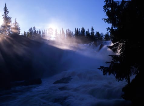 Beautiful mountain waterfall in sunshine