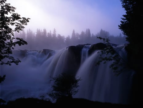 Beautiful waterfall in fog mountain 