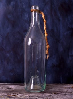 Old bottle isolated on painted background