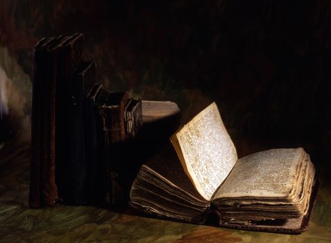 Stack of old books isolated on painted background 
