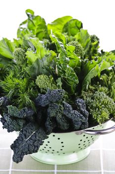 Dark green leafy fresh vegetables in metal colander