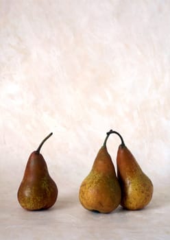 Three red pears isolated on painted background