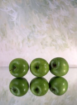 Three green apples isolated on mirror 