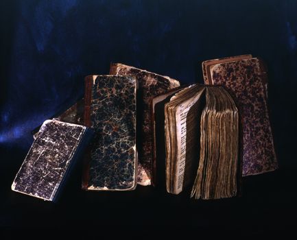 Pile of old books isolated on dark background