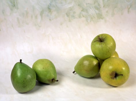 Green pears and apples isolated on painted background