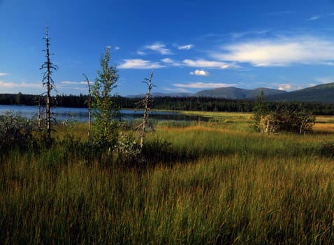 Beautiful autumn landscape of lake ,mountain and blue sky