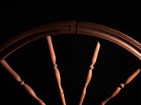 wheel of vintage wooden spinning closeup in dark