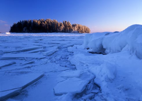 Blue ice floating and a small island in the lake