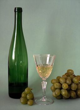 Wine,glass and frapes isolated on green background